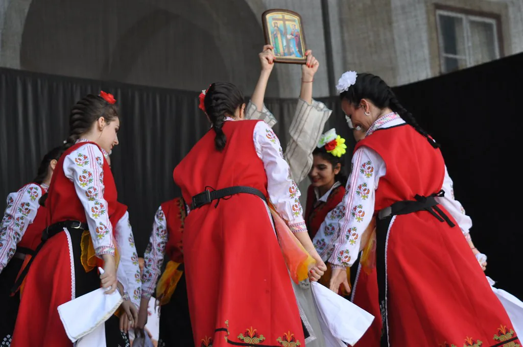 Bulgarian folk dancers in traditional embroidered costume performing the horo circle dance