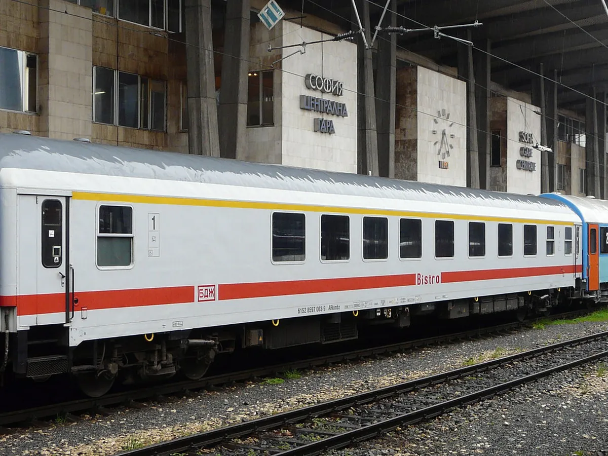 BDZ passenger train traveling through Bulgarian countryside with green rolling hills