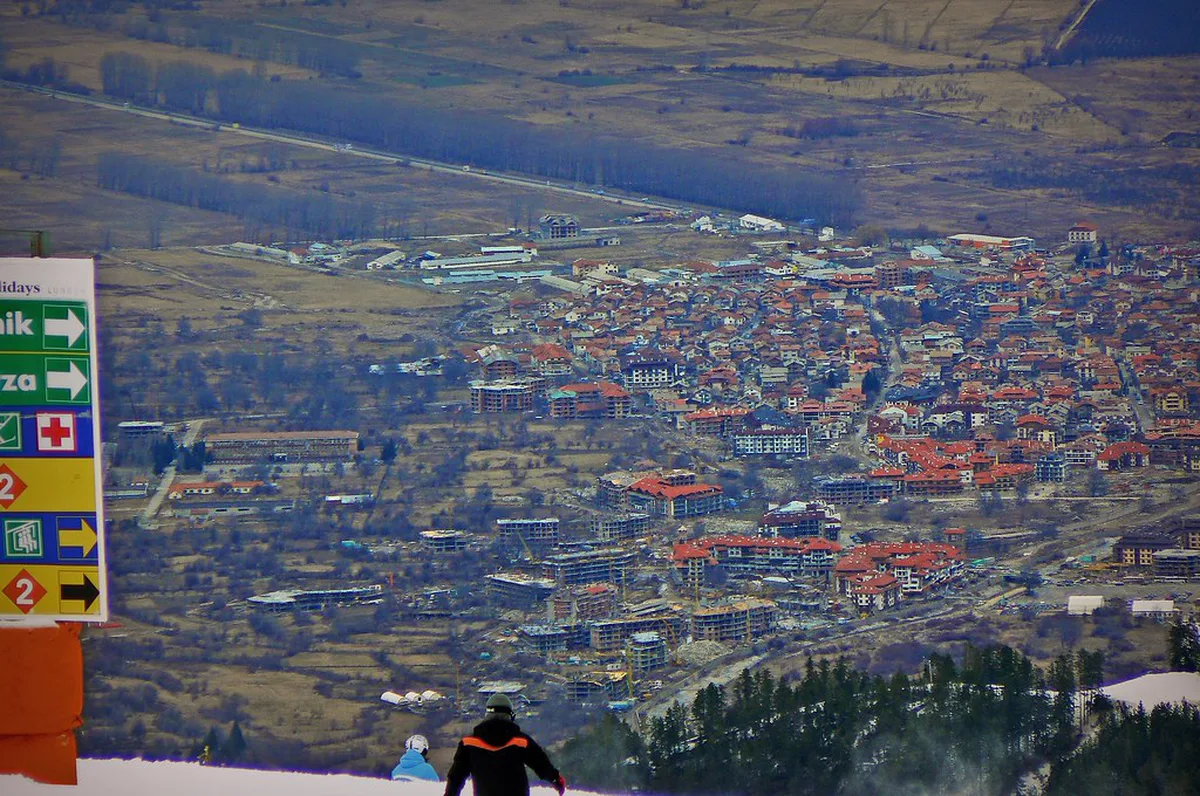 Snow-covered ski slopes and chalets at Bansko ski resort in the Pirin Mountains of Bulgaria in winter