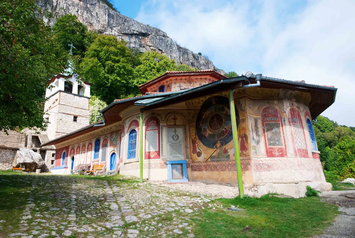 Vibrant 19th-century frescoes by Zahari Zograf covering the interior walls of Troyan Monastery church